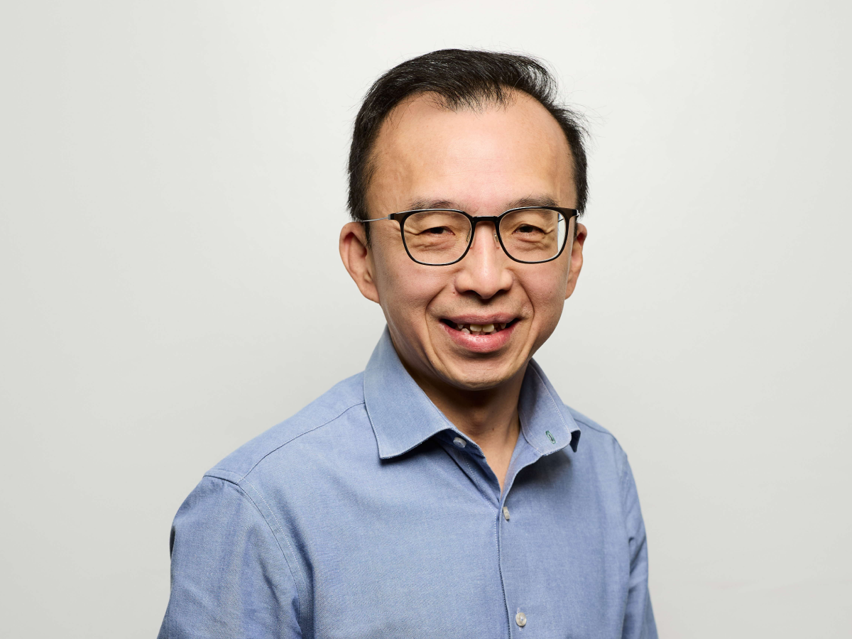 Mr Cheng Yong Tai in a light blue shirt smiling with both hands in his pocket